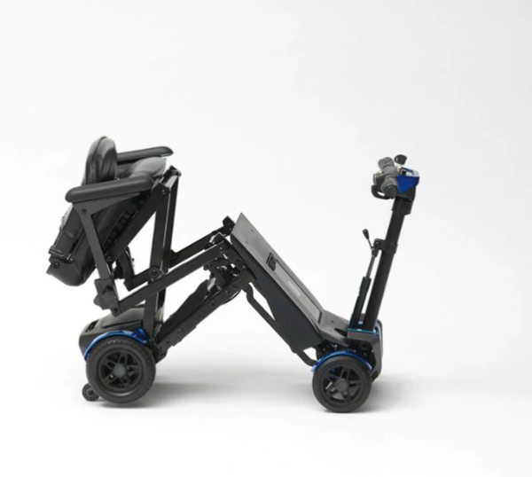 Compact black motorized wheelchair on white background