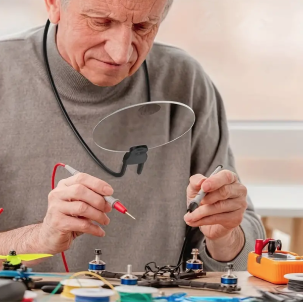 Senior technician repairing electronics in workshop