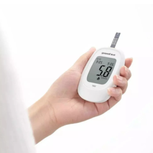 Hand holding portable digital glucose meter for diabetes check