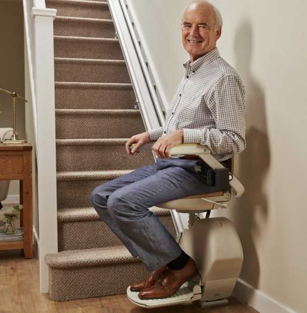 Senior man using stairlift at home for accessibility