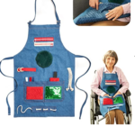 Elderly woman in wheelchair wearing sensory stimulation apron.