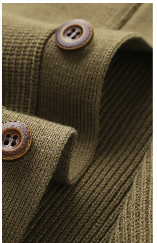 Close-up of brown buttons on olive green cardigan