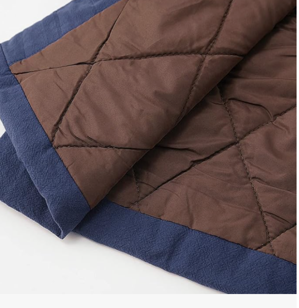 Close-up of a quilted brown and blue blanket.