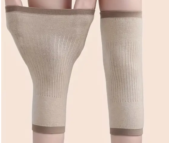 Beige compression knee sleeves on human legs