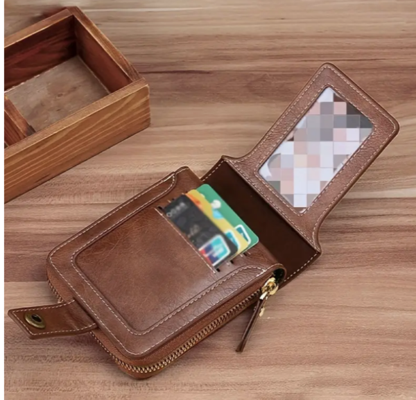 An open brown leather wallet resting on a wooden surface.