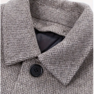 Close-up of a grey herringbone fabric shirt collar.