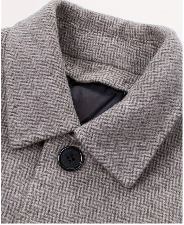 Close-up of a grey herringbone fabric shirt collar.