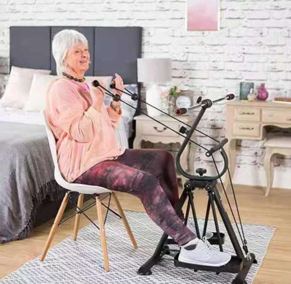 An older woman working out on a stationary bike at home.