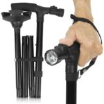 Elderly hand holding walking cane with light